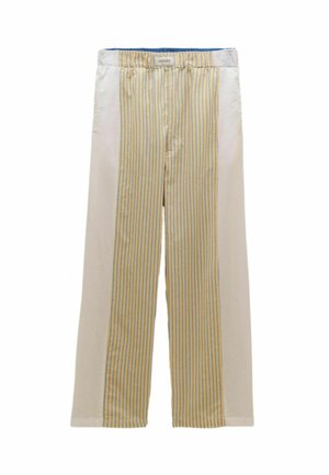 Krémové nohavice so stredovým panelom žltých a modrých priečnych pásov, elastickým pásom a štítkom s nápisom "JOULES" na vnútornej prednej strane.