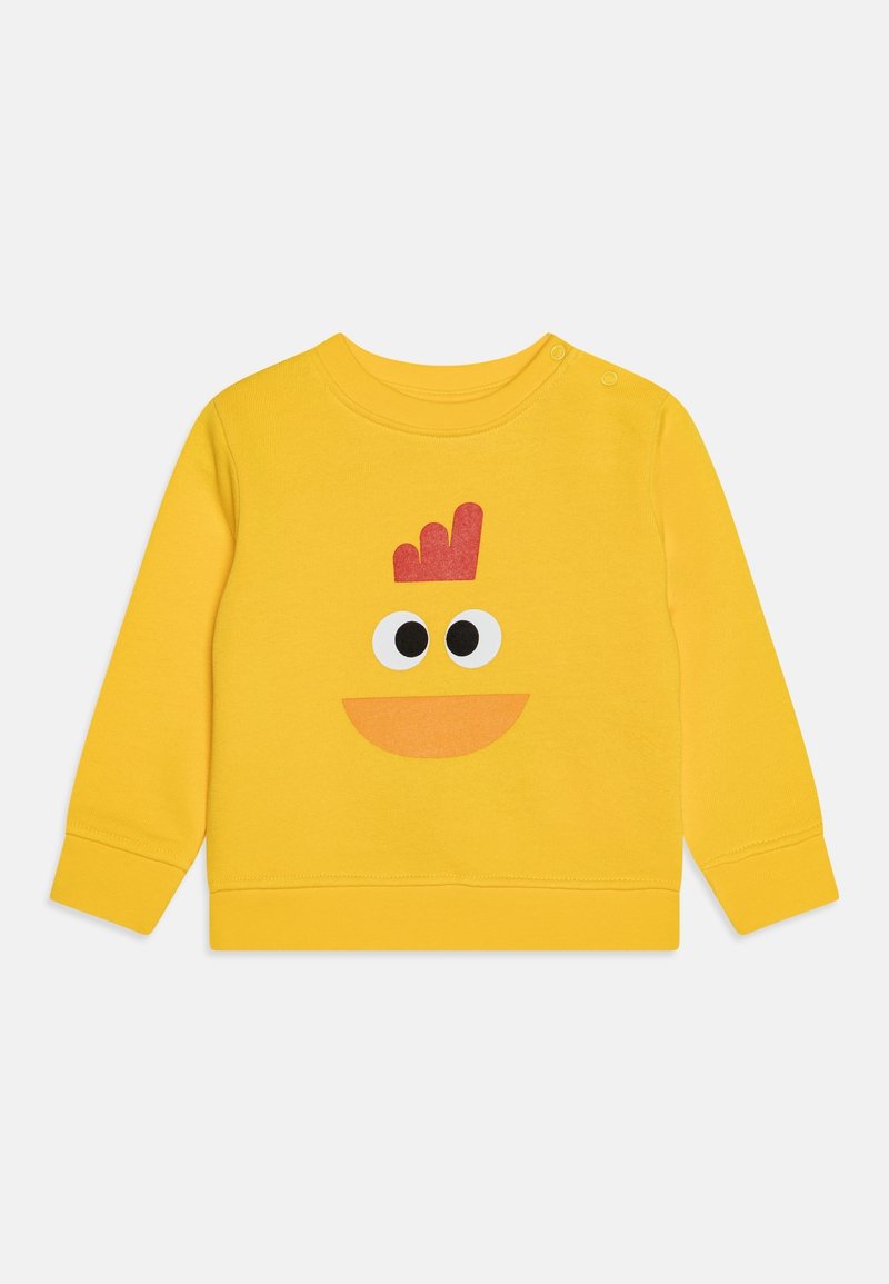 Yellow cotton sweatshirt featuring a playful character design with large black eyes and an orange mouth, complemented by a red crown detail.