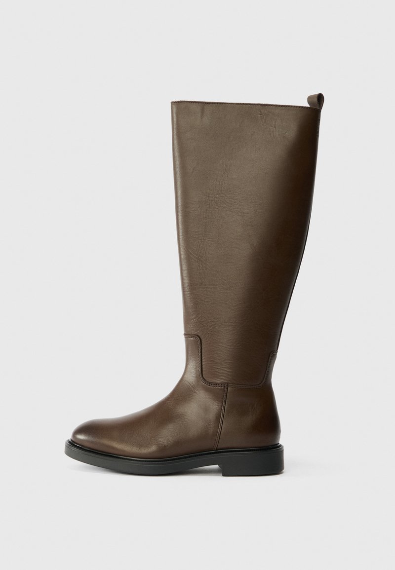 Brown leather knee-high boot with a smooth texture, rounded toe, low black heel, and a pull tab at the top for easy wear.