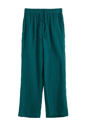 Pantalones sueltos de color azul verdoso con cintura elástica, cordón frontal, bolsillos laterales y tejido texturizado.