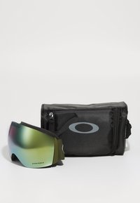 Skibril met een groene lens en zwarte band, vergezeld van een zwarte opbergcase met een grijs logo en ritssluiting.