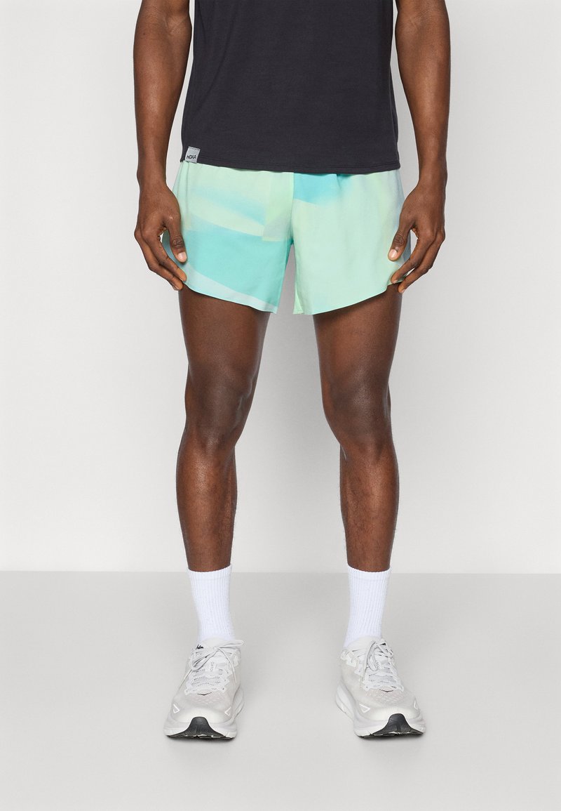 Letvægts svømmetights i gradient nuancer af mintgrøn og aqua, med en behagelig pasform og blødt, hurtigttørrende stof.