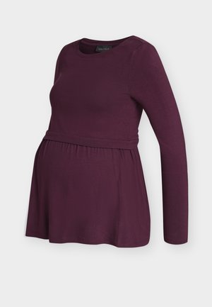 Langarm zwangerschapstop in diep paars, met een aansluitende borst en een geplooide empire-tailoring voor comfort en stijl.