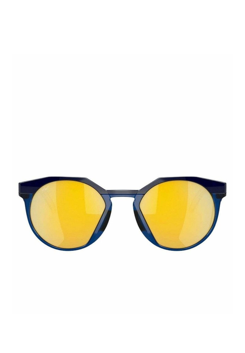 Lunettes de soleil rondes avec une monture en plastique bleu et de grandes verres miroir jaunes. Caractéristiques bords angulaires et design minimaliste.