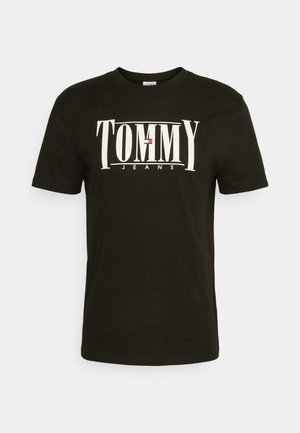 Black cotton t-shirt with short sleeves featuring a white "TOMMY JEANS" logo across the front. Smooth texture, crew neck design.