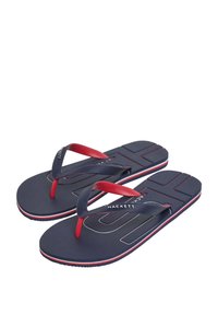 Infradito navy con fasce in gomma rossa, soletta testurizzata e logo del marchio bianco a contrasto. Caratterizzati da un design a strati e una suola a righe.