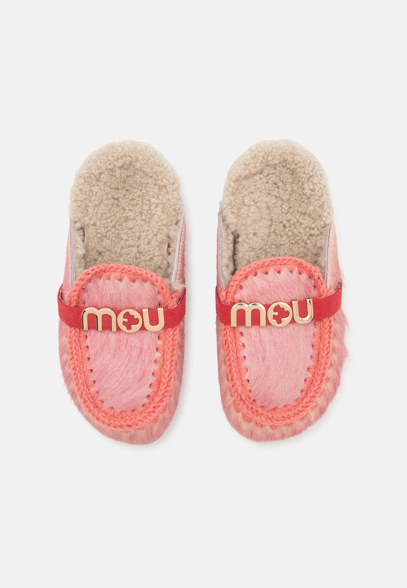 Pair of pink fuzzy slip-on slippers with beige fleece lining and red strap featuring gold "mou" logo on top.