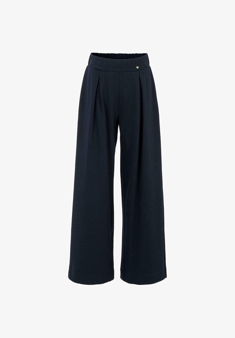 Pantalons larges taille haute, couleur marine, avec des plis sur le devant et un petit détail en cœur métallique au niveau de la ceinture.