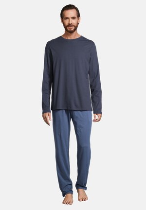 Marineblaues Langarmshirt kombiniert mit hellblauen Schlafanzughosen, beide aus weichem Material. Die Hosen haben eine lockere Passform und einen elastischen Bund.