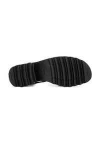 Black rubber shoe sole featuring a ridged texture with horizontal and vertical lines for traction. Simple, flat design with no additional hardware.