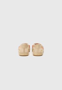 Beige Espadrilles mit floralem Stickmuster, Obermaterial aus Canvas, Jutesohle und flachem Absatz. Mit kleinen Hardwaredetails an der Ferse.