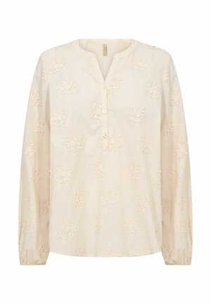 Krēmkrāsas kokvilnas blūze ar garām piedurknēm, izšūtu ziedu rakstu, pogu aizdari priekšpusē un apaļu kakla izgriezumu. Mīksta tekstūra ar sapulcinātām aprocēm.