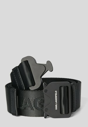 Czarny nylonowy pasek z dużą metalową klamrą szybkiego zwalniania, na klamrze nadruk "KARL LAGERFELD" oraz tłoczona nazwa marki na pasku.