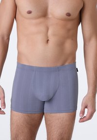 Boxer da uomo grigi con una trama a coste e un design del pouch sagomato. Presentano un elastico morbido in vita e una silhouette aderente.