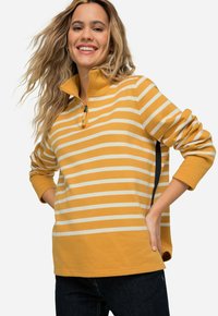 Pullover a maniche lunghe a righe gialle e bianche con colletto con zip e fessure laterali. Tessuto in cotone con una consistenza morbida.