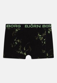 Boxer shorts negros con un patrón floral en verde oscuro, con una cinturilla elástica negra etiquetada "BJÖRN BORG" en verde claro.