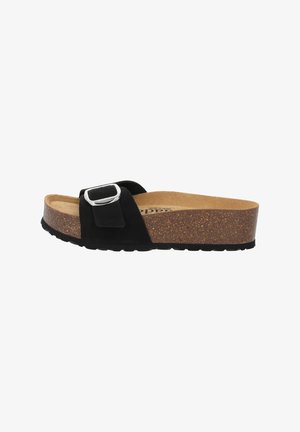 Sandalo scivolato in suede nero con un accentuato cinturino in argento, suola intermedia in sughero e suola esterna in gomma testurizzata, progettato per il comfort e l'uso quotidiano.