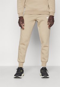 Puma LOGO - Pantalones deportivos - oak branch