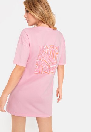 Pink cotton t-shirt dress featuring a large graphic design in shades of pink with "NO RISK NO STORY" text on the back. Short sleeves.