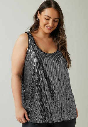 Top sin mangas en negro y plateado con lentejuelas dispuestas en rayas verticales, con escote redondeado y corte holgado.