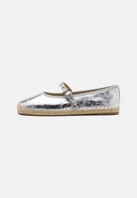 Silver metallic ballet flats with a round toe, featuring an ankle strap and a woven jute sole. Smooth texture with a shiny finish.