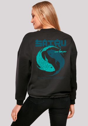 Black sweatshirt featuring a teal graphic of two koi fish, with text "SAITRU urban," and a description at the bottom. Ribbed cuffs.