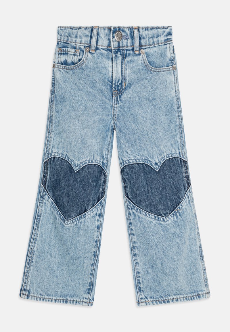 Light blue denim jeans with heart-shaped dark blue patches on the knees. Features a five-pocket design and a button closure. Wide-leg fit.