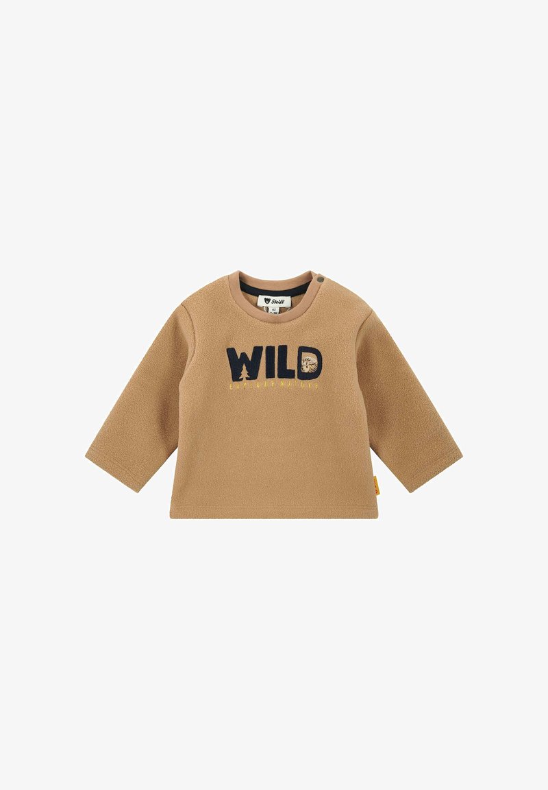 Maglietta in pile per bambino con maniche lunghe di colore tan, con la scritta "WILD" e una grafica di faccia di animale sul davanti, colletto rotondo e bottoni a pressione sulle spalle.
