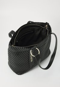 Black woven leather handbag with a smooth texture, gold hardware, zippered closure, and an interior pocket. Features a detachable shoulder strap.