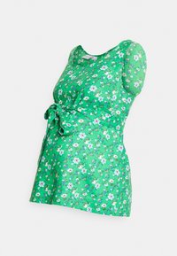 T-shirt de maternidade verde com padrão floral, mangas curtas, detalhe de laço na cintura e um tecido de textura suave. Leve e respirável.