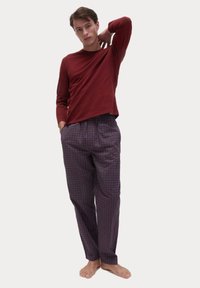 Maroon long-sleeve top paired with patterned purple pants featuring small white and blue dots. Soft fabric, relaxed fit, no visible hardware.