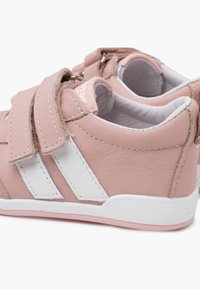 Pink synthetic leather shoes with white accents and Velcro straps. Rounded shape, textured soles, and padded interior for comfort.