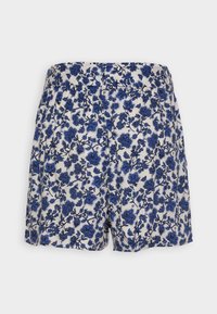 Shorts fleuris avec un fond blanc présentant des fleurs bleues et des contours noirs. Taille élastique; tissu léger et lisse.