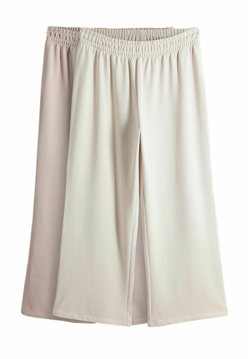 Ľahké, dvojfarebné culottes s širokým elastickým pásom a voľnou siluetou; látka má hladkú textúru a jemný odtieň.