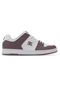 DC sneakers featuring a leather upper in white and brown, with a rubber sole, laces, and logo detail on the side. Flat, round toe design.