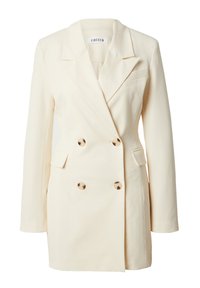 Doppelt geknöpfter Creme-Blazer mit Reverskragen, goldfarbenen Knöpfen und zwei Fronttaschen; strukturiertes Design mit leicht übergroßer Passform.