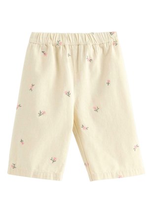 Kremfarvede shorts til tumlinger med små lyserøde blomsterprint og elastik i taljen, lavet af blødt stof.