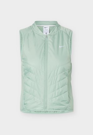 Jasnozielona bezrękawnik Nike z zamkiem błyskawicznym z przodu i pikowanym wzorem chevron na przedzie.