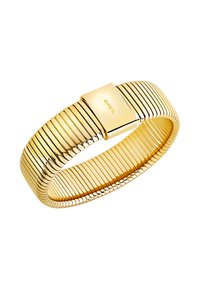 Bracciale in metallo color oro con design flessibile e rigato. Presenta una chiusura rettangolare con il nome del marchio "BREIL" inciso.