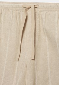 Bež hlače iz lanu s elastičnim pasom in trakom za zavezovanje iz tkanine, z navpičnimi detajli šivov.