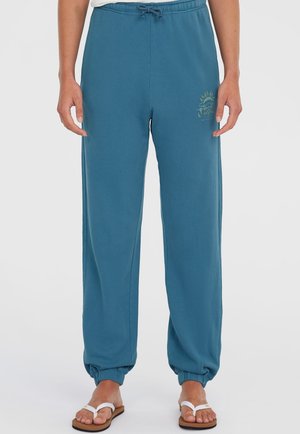 Blå bomulds sweatpants med elastisk talje, justerbar snor og sammenflettede ankler. Har små solgrafikdetaljer på låret.