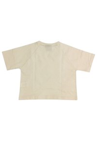 T-shirt a maniche corte, colore crema, con scollo rotondo, maniche raglan e una texture liscia. Presenta un branding minimale sull'orlo.