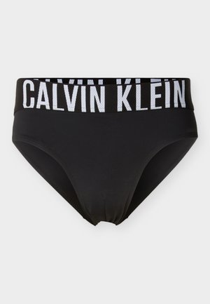 Bas de bikini noir avec une large ceinture élastique noire arborant le logo blanc « CALVIN KLEIN ». Texture lisse et coupe classique.
