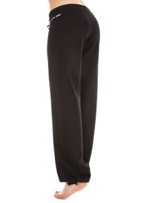 Black sweatpants made of soft fabric, featuring a drawstring waist, cuffed hems, and logo detailing on the waistband.