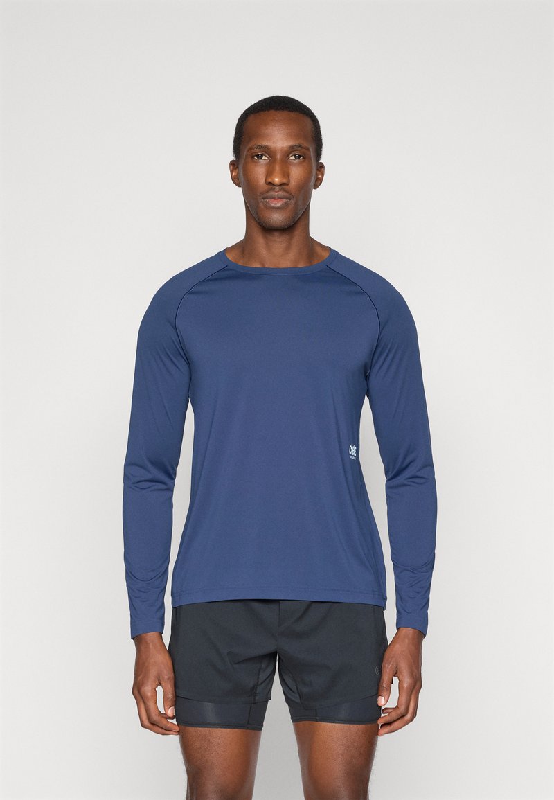 Long-sleeve navy athletic shirt made of smooth, lightweight material with raglan sleeves and a small logo on the lower side.