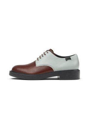 Brown and light blue leather shoes with a round toe, five eyelets, and a black chunky rubber sole. Smooth texture and contrasting colors.