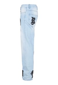 Light blue denim jeans featuring black embroidered designs, including a letter "R" and palm trees, with distressed detailing on the legs.