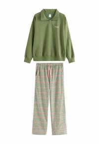 Green zip-up sweatshirt with "PARIS" text; paired with plaid pajama pants featuring green, white, and pink check patterns.