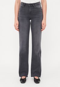 Høytlivte, rette jeans i mørkegrå denim. Har tradisjonelt fem-lommers design og svak falming over stoffet.