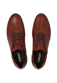 Brązowe skórzane buty o gładkiej i perforowanej strukturze, z sznurowanym zapięciem i oznaczeniem wewnątrz buta.